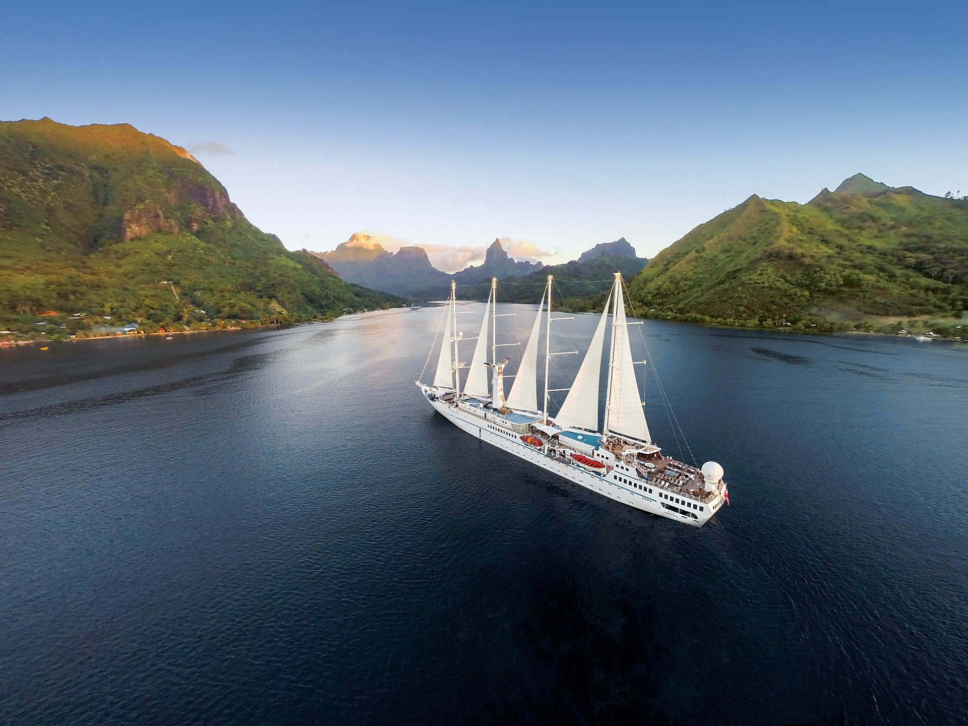 Windstar Star Breeze sailing into Moorea with the island's peaks in the background
